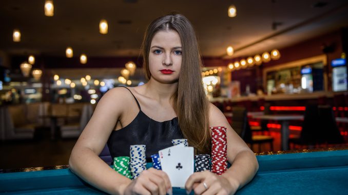 Woman in casino showing combination of aces